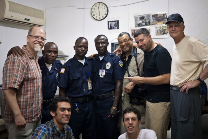 David Trotman-Wilkins, (center/back row), makes peace still can smile after being forced by Liberian police to erase two photographs he took of the new U.S. Embassy in Monrovia.